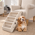 Escaleras plegables para perro junto a un sofá con un perro pequeño